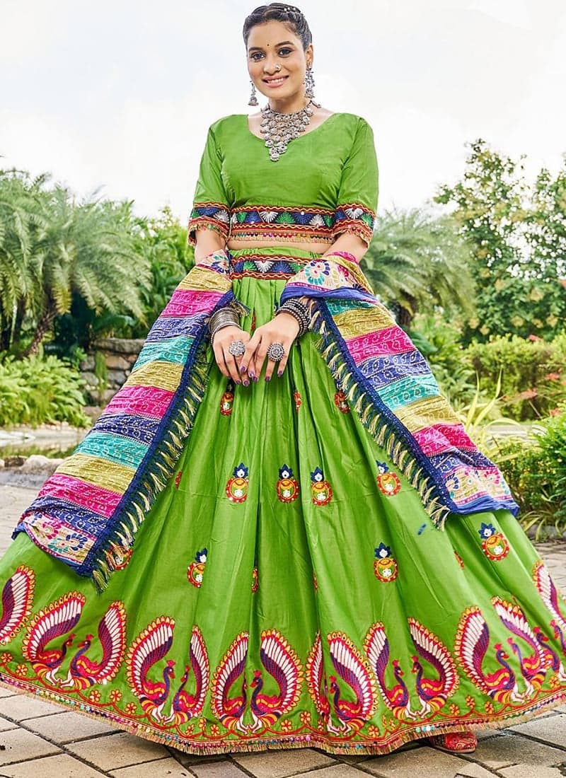 Model twirling in a green mirror-work chaniya choli