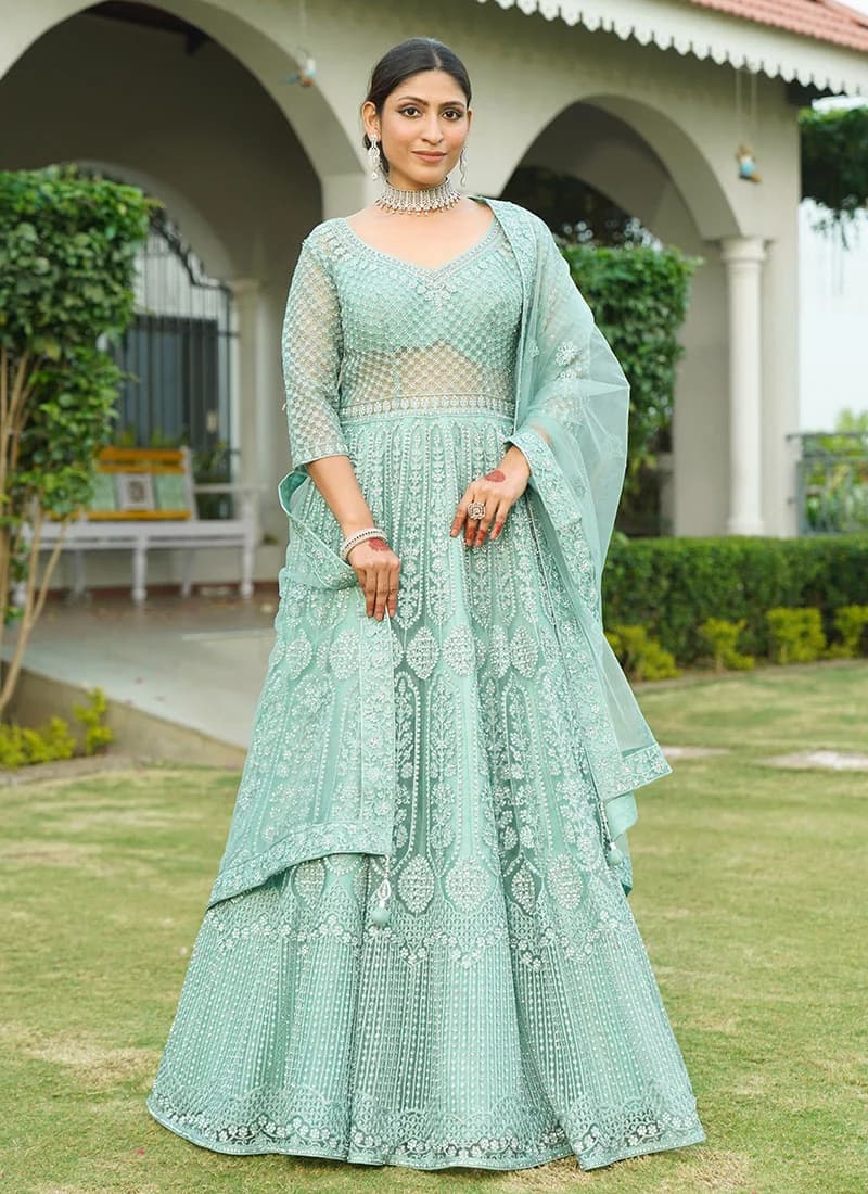 Model in a turquoise net anarkali with dupatta