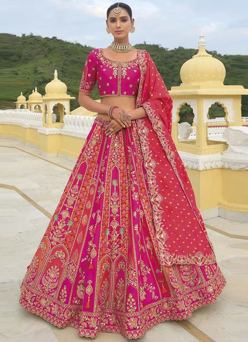 Model in a hot-pink silk lehenga with zari and sequin embroidery